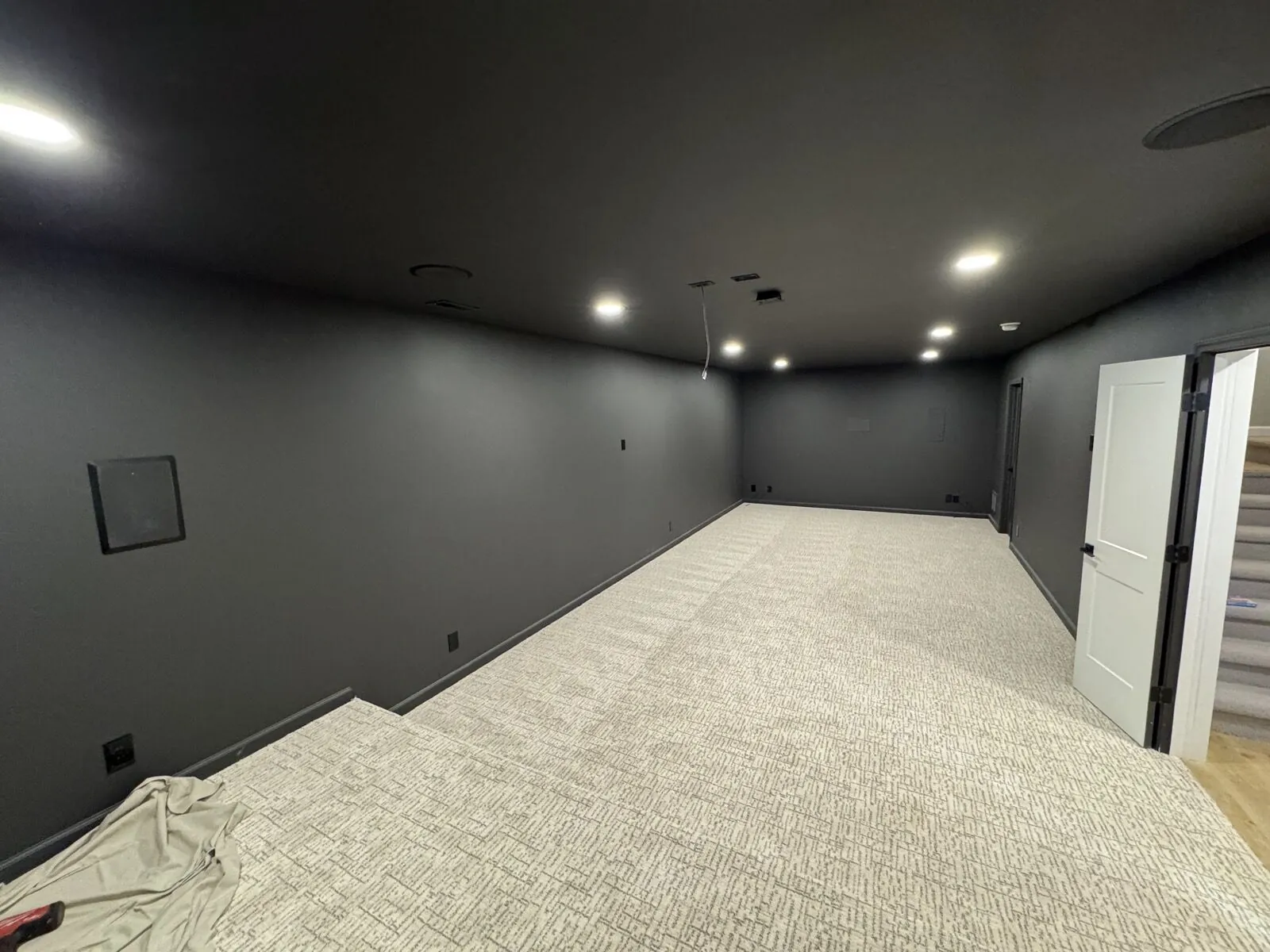 Basement renovation with custom flooring and recessed lighting