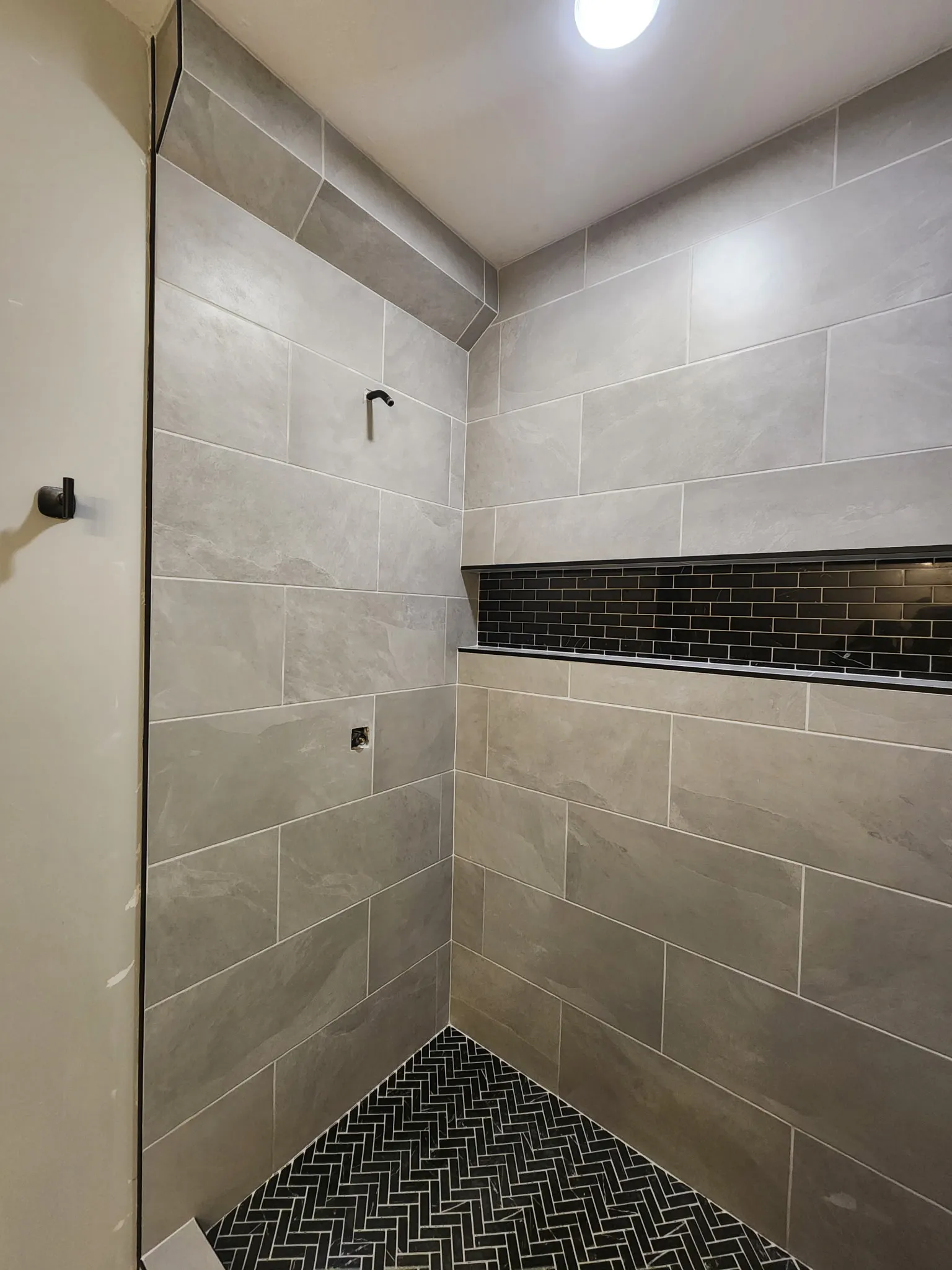 Custom tub surround with waterproof tile work by LongView Renovation